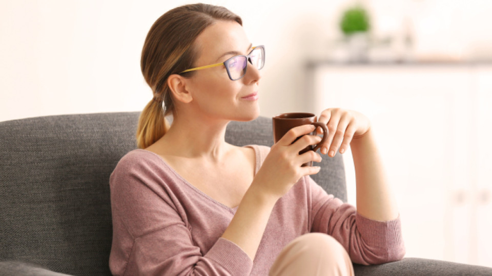 Woman in glasses drinking coffee