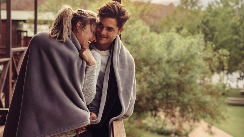 Young couple in blankets outside