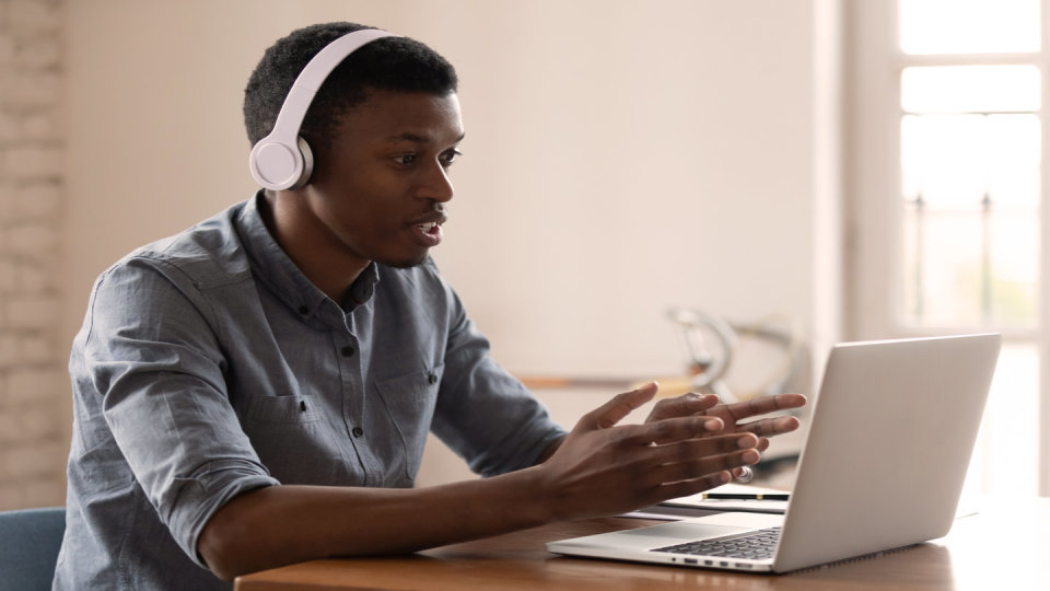 Man at laptop with head phones