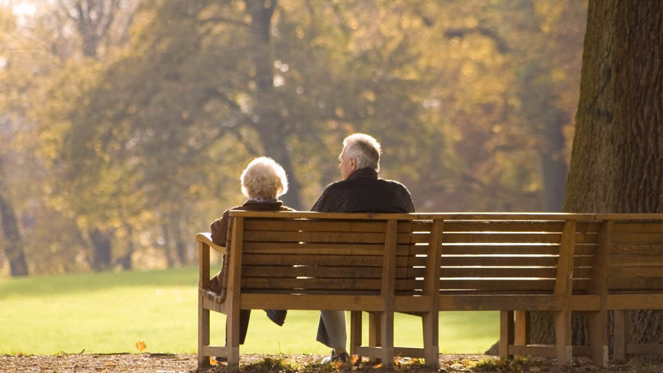 Newsroom - anonymous behind old couple 